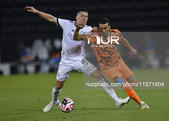 Andres Villa (L) of Al-Sadd SC battles for the ball with Ali Said Al-Muhannadi (R) of Umm Salal SC during the Ooredoo Qatar Stars League 24/...