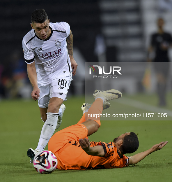 Andres Villa (L) of Al-Sadd SC battles for the ball with Ali Said Al-Muhannadi (R) of Umm Salal SC during the Ooredoo Qatar Stars League 24/...