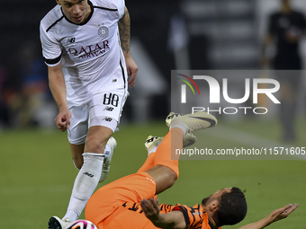 Andres Villa (L) of Al-Sadd SC battles for the ball with Ali Said Al-Muhannadi (R) of Umm Salal SC during the Ooredoo Qatar Stars League 24/...