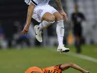 Andres Villa (top) of Al-Sadd SC battles for the ball with Ali Said Al-Muhannadi (R) of Umm Salal SC during the Ooredoo Qatar Stars League 2...