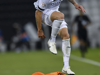 Andres Villa (top) of Al-Sadd SC battles for the ball with Ali Said Al-Muhannadi (R) of Umm Salal SC during the Ooredoo Qatar Stars League 2...