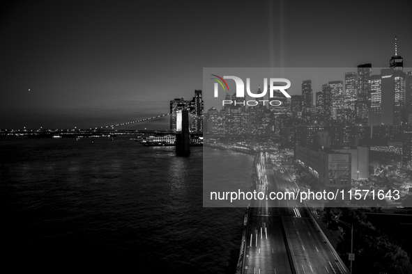 The annual Tribute in Light illuminates the skyline of lower Manhattan and One World Trade Center in New York City as it reflects in the top...