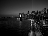 The annual Tribute in Light illuminates the skyline of lower Manhattan and One World Trade Center in New York City as it reflects in the top...