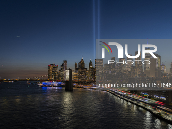 The annual Tribute in Light illuminates the skyline of lower Manhattan and One World Trade Center in New York City as it reflects in the top...