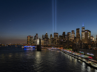 The annual Tribute in Light illuminates the skyline of lower Manhattan and One World Trade Center in New York City as it reflects in the top...