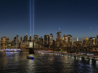 The annual Tribute in Light illuminates the skyline of lower Manhattan and One World Trade Center in New York City as it reflects in the top...