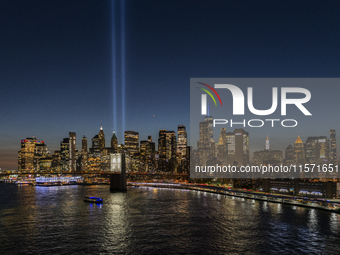 The annual Tribute in Light illuminates the skyline of lower Manhattan and One World Trade Center in New York City as it reflects in the top...