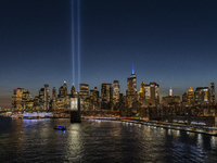 The annual Tribute in Light illuminates the skyline of lower Manhattan and One World Trade Center in New York City as it reflects in the top...