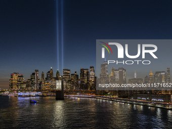 The annual Tribute in Light illuminates the skyline of lower Manhattan and One World Trade Center in New York City as it reflects in the top...