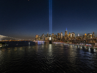 The annual Tribute in Light illuminates the skyline of lower Manhattan and One World Trade Center in New York City as it reflects in the top...