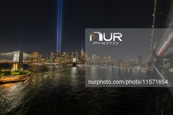 The annual Tribute in Light illuminates the skyline of lower Manhattan and One World Trade Center in New York City as it reflects in the top...