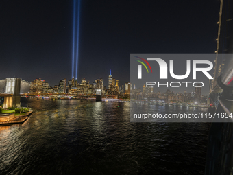 The annual Tribute in Light illuminates the skyline of lower Manhattan and One World Trade Center in New York City as it reflects in the top...