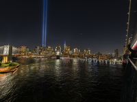 The annual Tribute in Light illuminates the skyline of lower Manhattan and One World Trade Center in New York City as it reflects in the top...