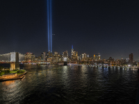 The annual Tribute in Light illuminates the skyline of lower Manhattan and One World Trade Center in New York City as it reflects in the top...