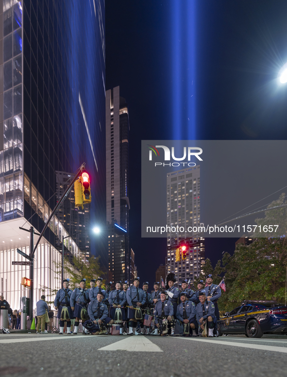 The annual Tribute in Light illuminates the skyline of lower Manhattan and One World Trade Center in New York City as it reflects in the top...