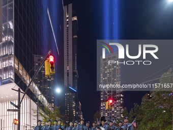 The annual Tribute in Light illuminates the skyline of lower Manhattan and One World Trade Center in New York City as it reflects in the top...