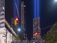 The annual Tribute in Light illuminates the skyline of lower Manhattan and One World Trade Center in New York City as it reflects in the top...