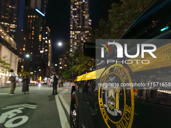 The annual Tribute in Light illuminates the skyline of lower Manhattan and One World Trade Center in New York City as it reflects in the top...