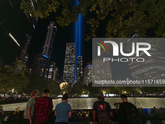 The annual Tribute in Light illuminates the skyline of lower Manhattan and One World Trade Center in New York City as it reflects in the top...