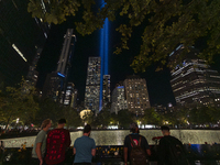 The annual Tribute in Light illuminates the skyline of lower Manhattan and One World Trade Center in New York City as it reflects in the top...