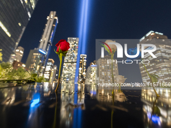 The annual Tribute in Light illuminates the skyline of lower Manhattan and One World Trade Center in New York City as it reflects in the top...