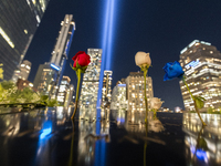 The annual Tribute in Light illuminates the skyline of lower Manhattan and One World Trade Center in New York City as it reflects in the top...