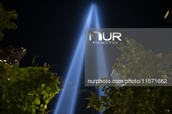 The annual Tribute in Light illuminates the skyline of lower Manhattan and One World Trade Center in New York City as it reflects in the top...