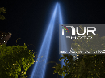 The annual Tribute in Light illuminates the skyline of lower Manhattan and One World Trade Center in New York City as it reflects in the top...