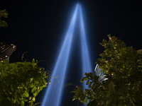 The annual Tribute in Light illuminates the skyline of lower Manhattan and One World Trade Center in New York City as it reflects in the top...