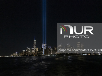 The annual Tribute in Light illuminates the skyline of lower Manhattan and One World Trade Center in New York City as it reflects in the top...