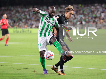 Youssouf Sabaly of Real Betis competes for the ball with Sergio Gonzalez of CD Leganes during the La Liga EA Sports match between Real Betis...