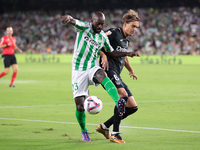 Youssouf Sabaly of Real Betis competes for the ball with Sergio Gonzalez of CD Leganes during the La Liga EA Sports match between Real Betis...