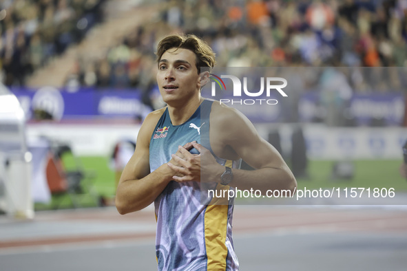 Armand Duplantis of Sweden reacts and celebrates holding his heart as he competes in the Men's Pole Vault during the Wanda Diamond League 20...