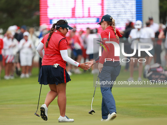 GAINESVILLE, VIRGINIA - SEPTEMBER 13: Lilia Vu of of Team USA celebrates her putt on the third green with teammate Sarah Schmelzel during Fo...