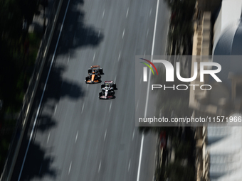 Nico Hulkenberg of Haas and Oscar Piastri of McLaren during first practice ahead of the Formula 1 Grand Prix of Azerbaijan at Baku City Circ...