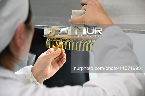 A worker tests diclofenac sodium injection at a pharmaceutical company in Suqian, China, on September 13, 2024. 