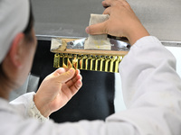 A worker tests diclofenac sodium injection at a pharmaceutical company in Suqian, China, on September 13, 2024. (