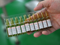 A worker shows a finished product of diclofenac sodium injection at a pharmaceutical company in Suqian, China, on September 13, 2024. (