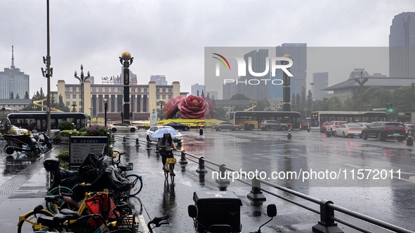 Citizens travel in the rain in Chengdu, China, on September 14, 2024. 