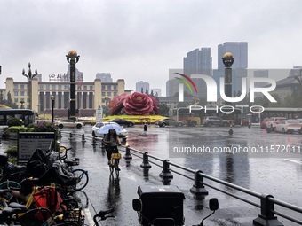 Citizens travel in the rain in Chengdu, China, on September 14, 2024. (