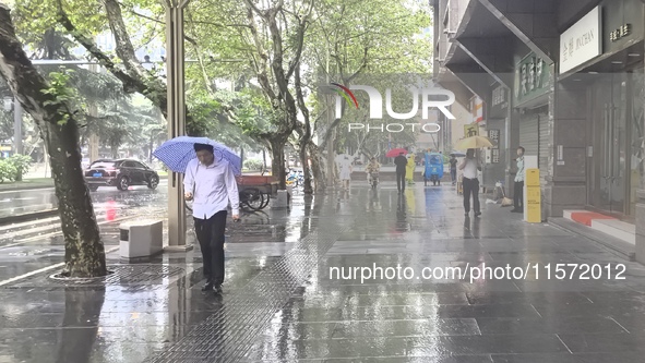 Citizens travel in the rain in Chengdu, China, on September 14, 2024. 