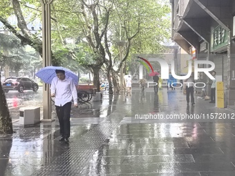 Citizens travel in the rain in Chengdu, China, on September 14, 2024. (