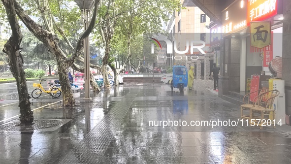 Citizens travel in the rain in Chengdu, China, on September 14, 2024. 