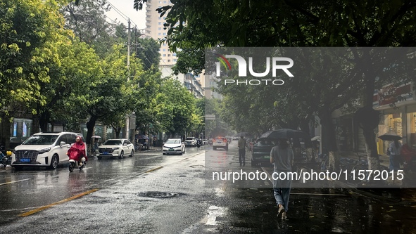 Citizens travel in the rain in Chengdu, China, on September 14, 2024. 