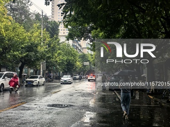 Citizens travel in the rain in Chengdu, China, on September 14, 2024. (