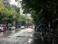 Citizens travel in the rain in Chengdu, China, on September 14, 2024. (