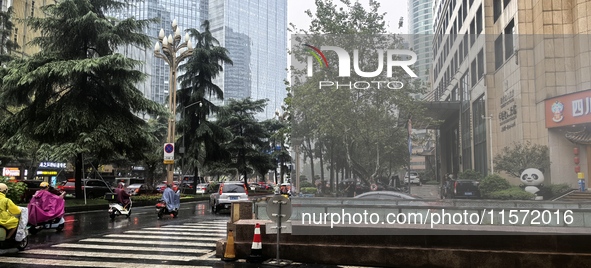 Citizens travel in the rain in Chengdu, China, on September 14, 2024. 