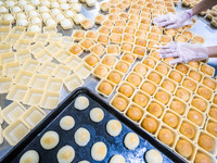 Workers make handmade mooncakes at a food production workshop in Bijie, China, on September 12, 2024. (