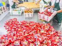 Workers make handmade mooncakes at a food production workshop in Bijie, China, on September 12, 2024. (