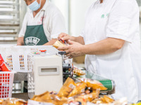 Workers make handmade mooncakes at a food production workshop in Bijie, China, on September 12, 2024. (